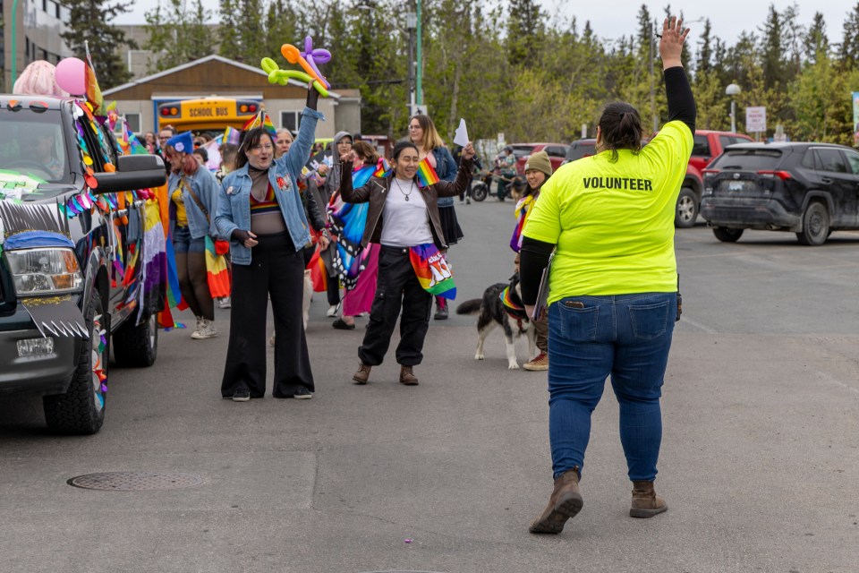Northern Mosaic Network's Chelsea Thacker, right, gets parade participants ready. Ollie Williams/Cabin Radio