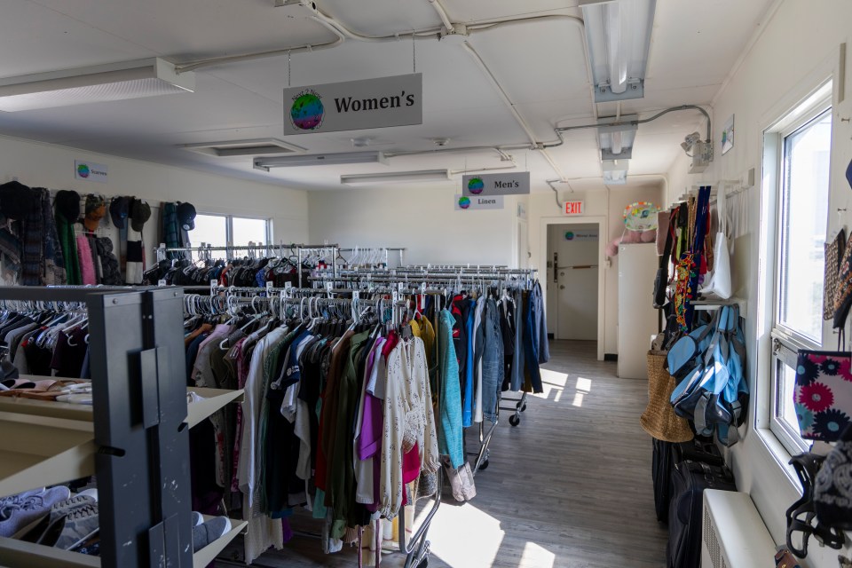Clothing racks inside Next to New. Ollie Williams/Cabin Radio