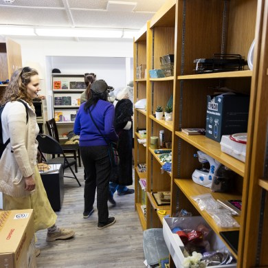 People browse shelves of the Next to New thrift store during a tour on June 20, 2025. Ollie Williams/Cabin Radio