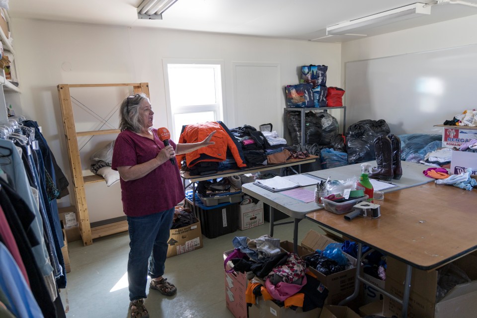 Patricia Davison inside a store room for donating clothing. Ollie Williams/Cabin Radio