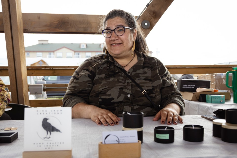 Amanda King-Demont at her King Crow Creations stall during Inuvik's June 21, 2025 Arctic Market. Ollie Williams/Cabin Radio