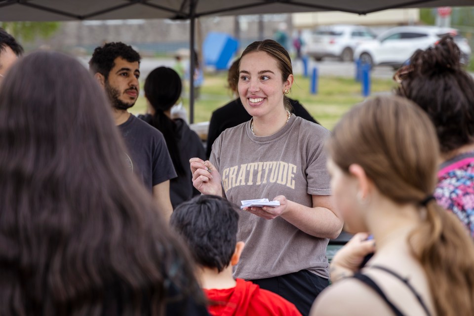 Karis Dekwant, centre, takes orders at Inuvik's National Indigenous Peoples Day celebrations on June 21, 2025. Ollie Williams/Cabin Radio