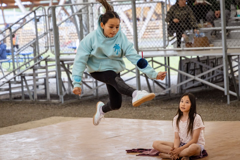 A demonstration of one-foot high kick at Inuvik's National Indigenous Peoples Day celebrations on June 21, 2025. Ollie Williams/Cabin Radio