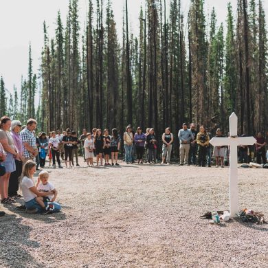 Tom Frith's family and friends from Yellowknife, left, along with community members from Fort Good Hope, gather a year later at the crash site. Sarah Pruys/Cabin Radio