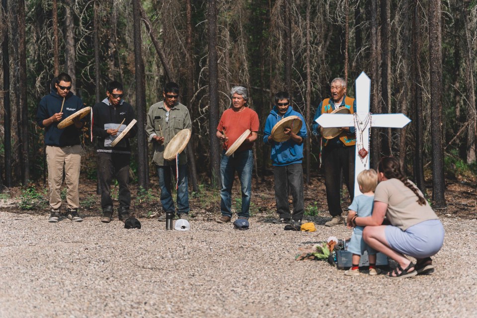 The K'asho Got'ine Drummers perform a prayer song at the site of the crash. Sarah Pruys/Cabin Radio