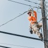 A power technician at work in June 2025. Sarah Pruys/Cabin Radio