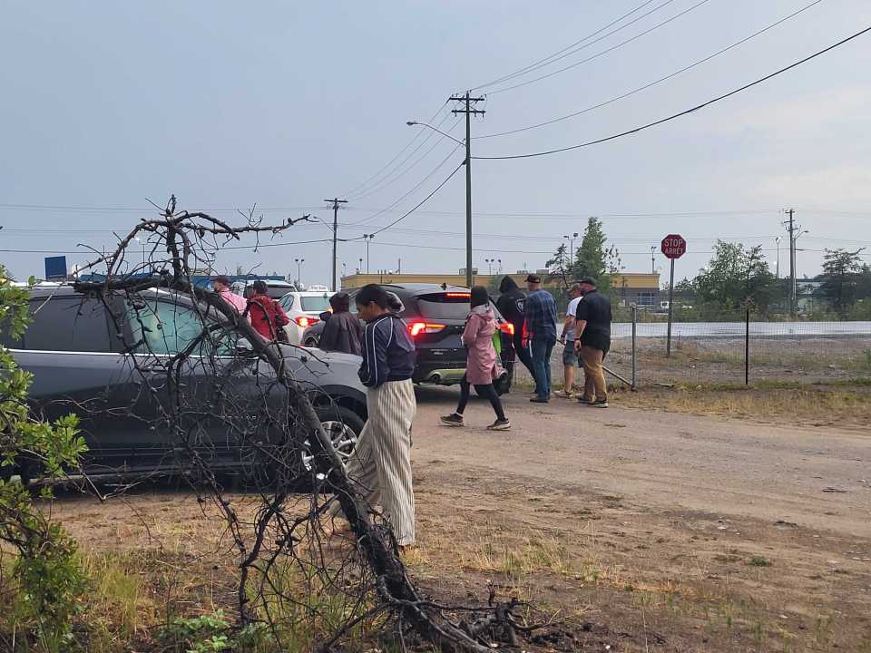 People leave the Folk on the Rocks site during a storm on July 18, 2025. Serra Hamilton/Cabin Radio