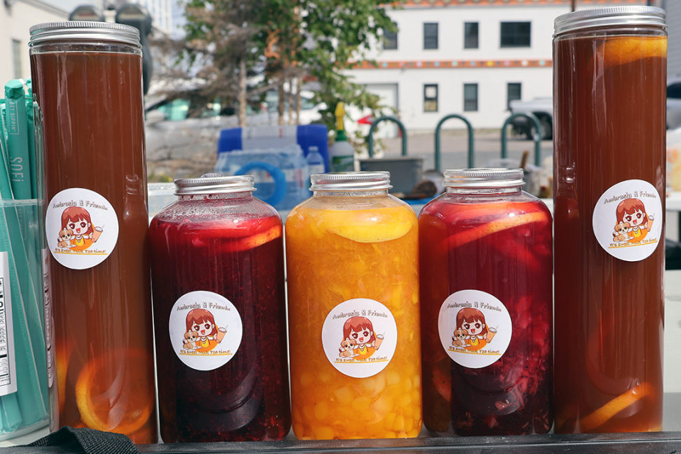 5 glass jars filled with cut up fruits and juice.