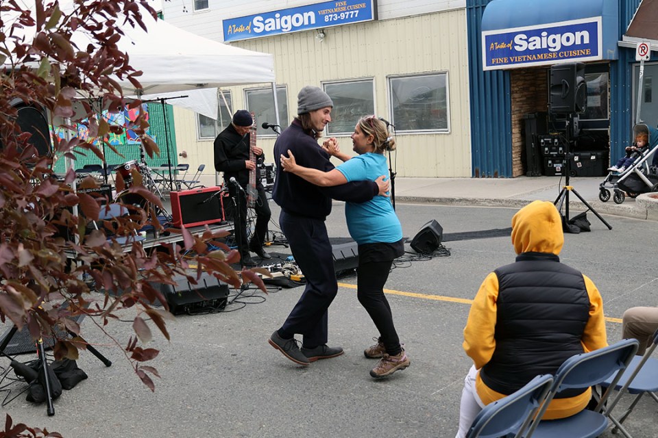 Man and woman dance to a live musical performance
