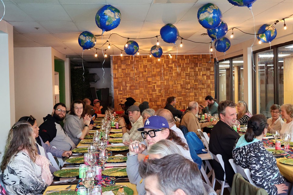 Diners seated at long tables waiting between courses.