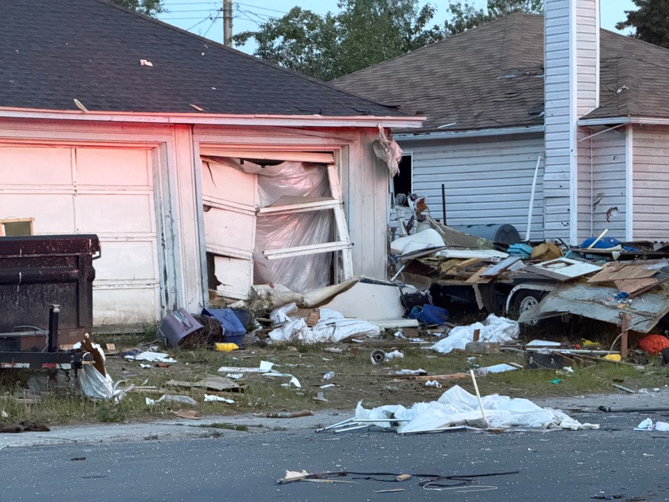 Damage to a set of garages on the street. Ollie Williams/Cabin Radio