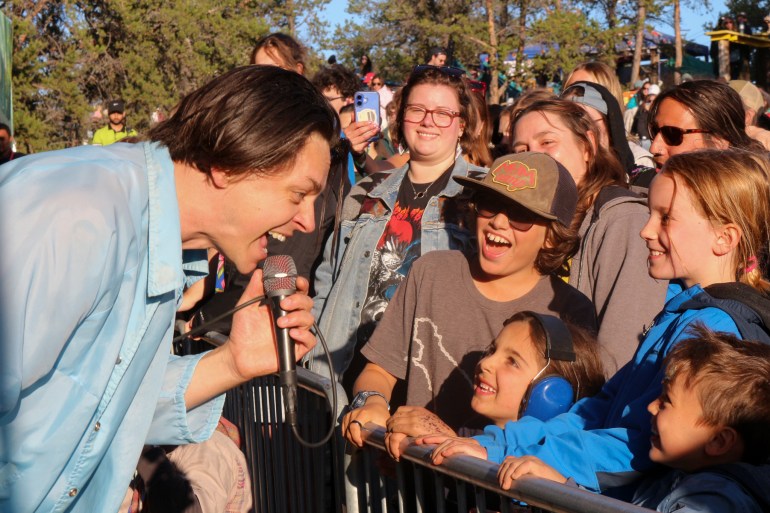 Peter Dreams engages with young crowd members at the Lawson Lundell Main Stage during Folk on the Rocks 2025. Serra Hamilton/Cabin Radio