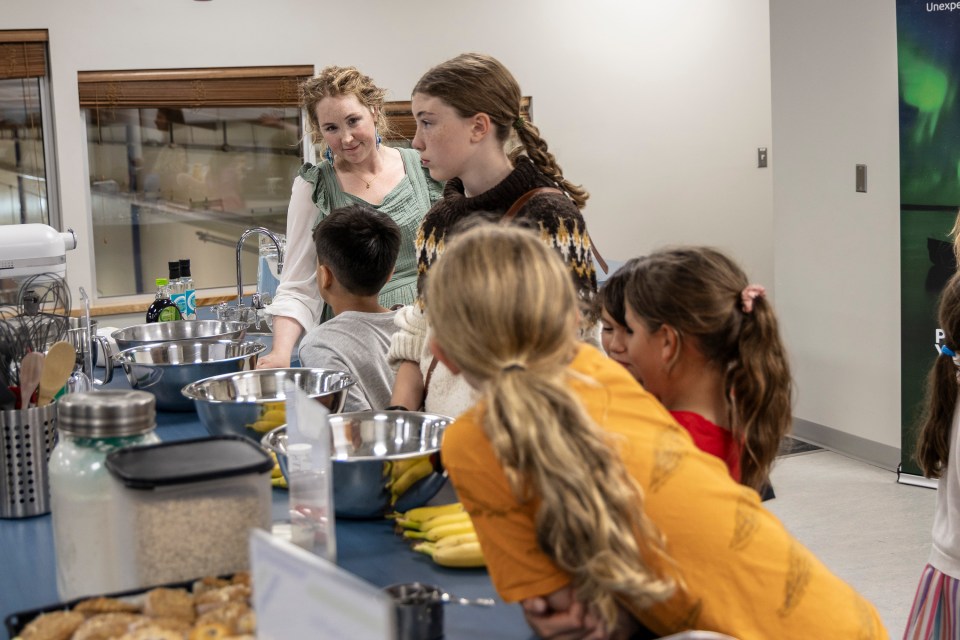 Fort Smith's director of community services and acting senior administrator, Emily Colucci, prepares for the PM's arrival with local youtb. Ollie Williams/Cabin Radio