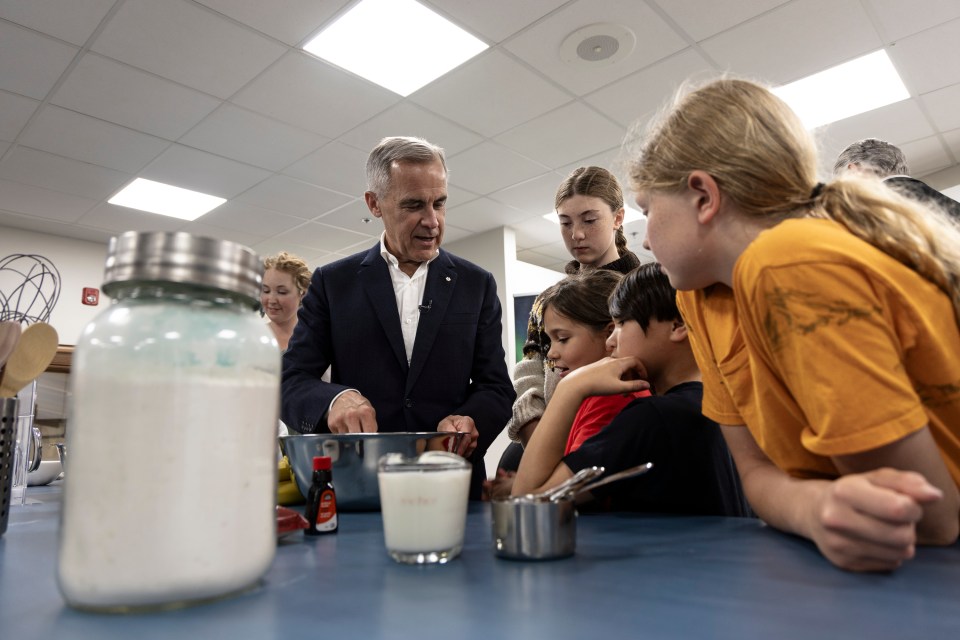 Mark Carney preps ingredients for muffins with Fort Smith youth. Ollie Williams/Cabin Radio