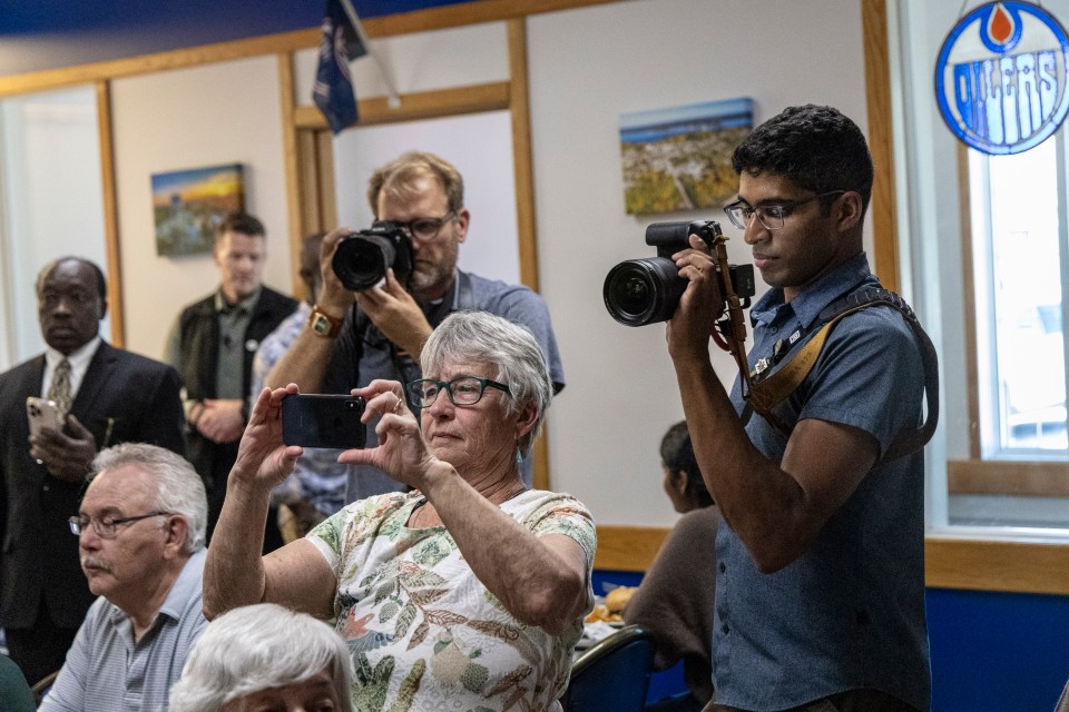 Fort Smith residents joined the photographers in trying to get the perfect shot of Mark Carney visiting Berro's. Ollie Williams/Cabin Radio