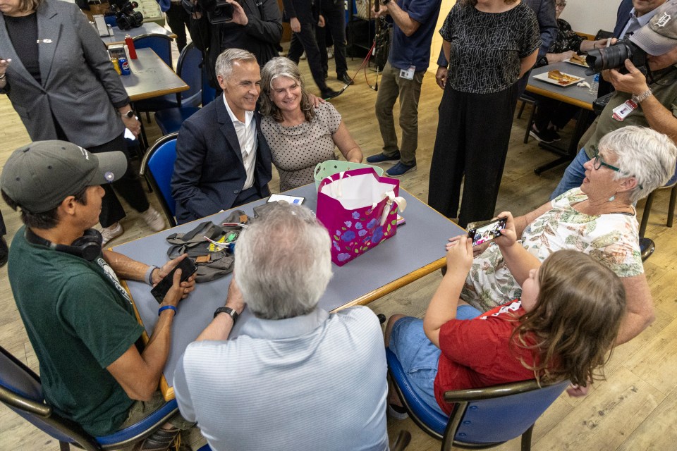 Mark Carney poses for photos with Berro's customers. Ollie Williams/Cabin Radio
