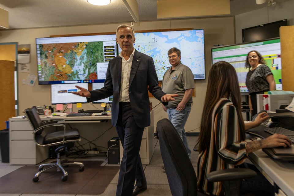Mark Carney enters a fire management centre in Fort Smith. Ollie Williams/Cabin Radio