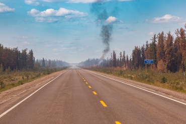 A wildfire by the side of Highway 3 on July 22, 2025. Ollie Williams/Cabin Radio