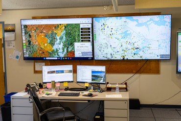 Digital maps inside an NWT Fire operations centre in July 2025. Ollie Williams/Cabin Radio