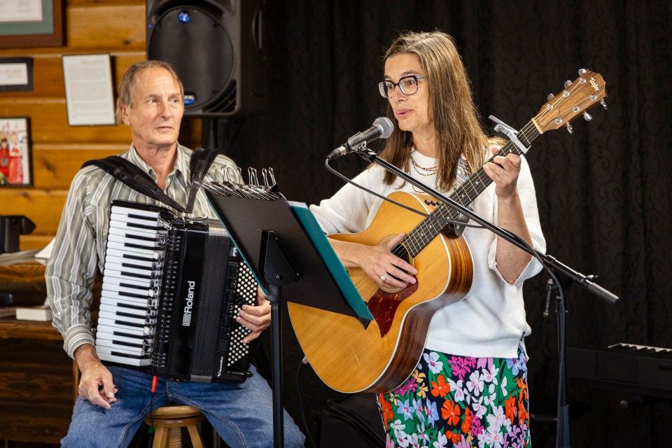 Karen Wall, right, performs at Hay Days at the Hay River Museum Society Heritage Centre. Ollie Williams/Cabin Radio