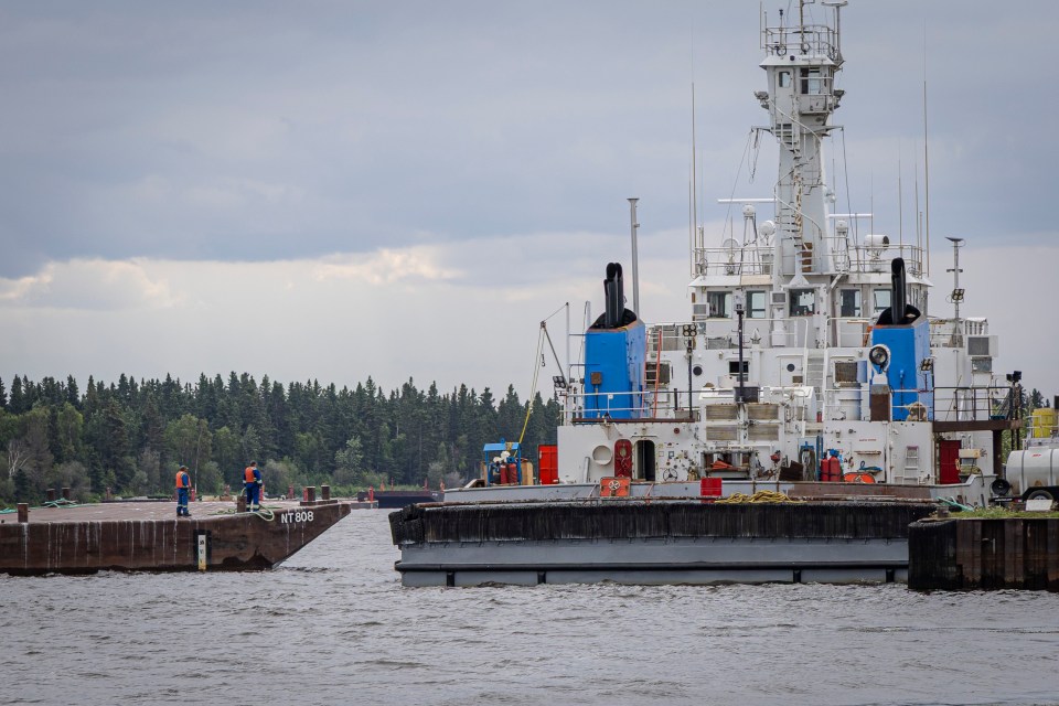 An MTS crew working on barges in the Hay River's East Channel. Ollie Williams/Cabin Radio