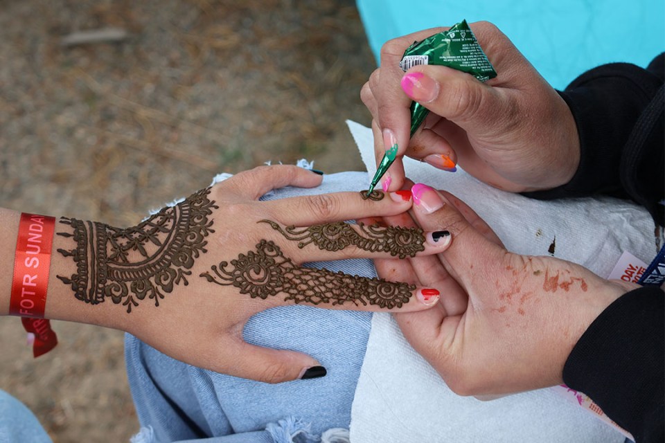 Henna patterns painted on a hand.
