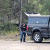 A police officer sets up a drone during an RCMP operation on July 11, 2025. Sarah Pruys/Cabin Radio