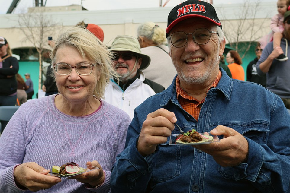 A man and a woman sample food at a demo