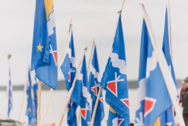 A photo of Tłı̨chǫ flags during a Trails of Our Ancestors trip published by the Tłı̨chǫ Government in 2024.