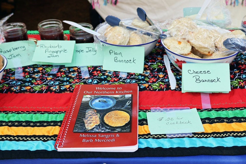 Table display of various types of bannock, jams and a cookbook