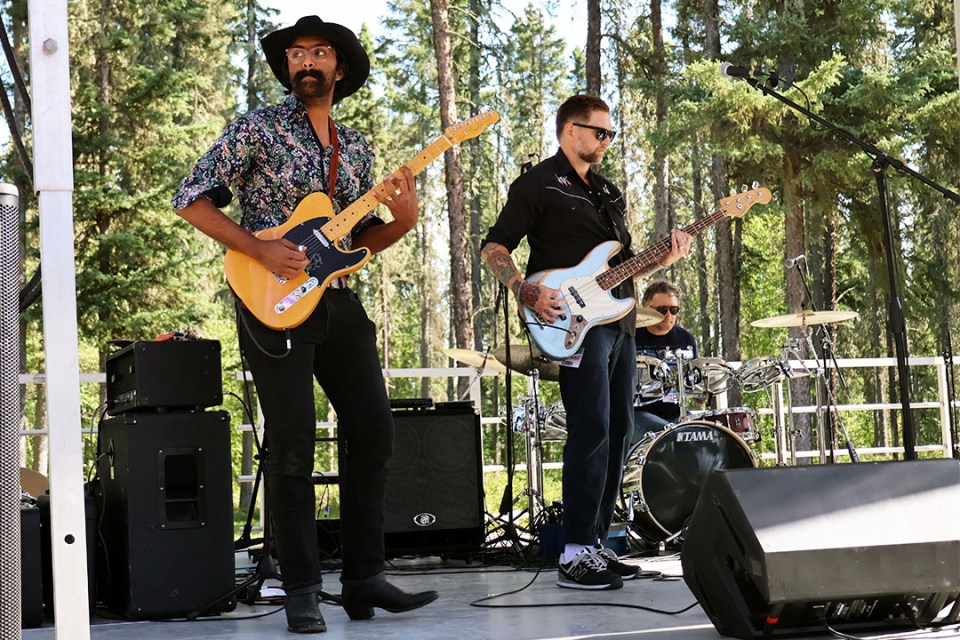 Two men with guitars perform on stage