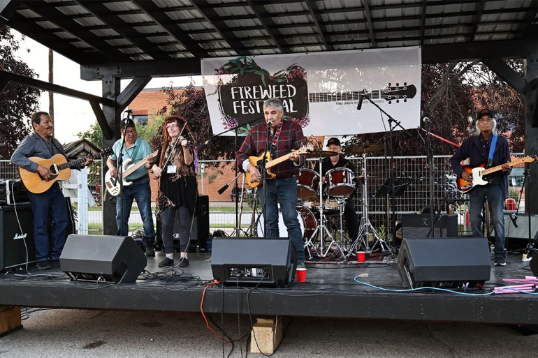 Musicians perform on stage at Fireweed Festival