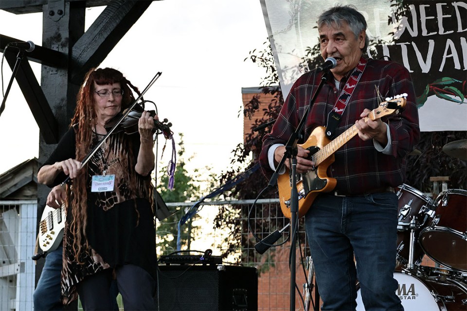 Man and woman play instruments on stage