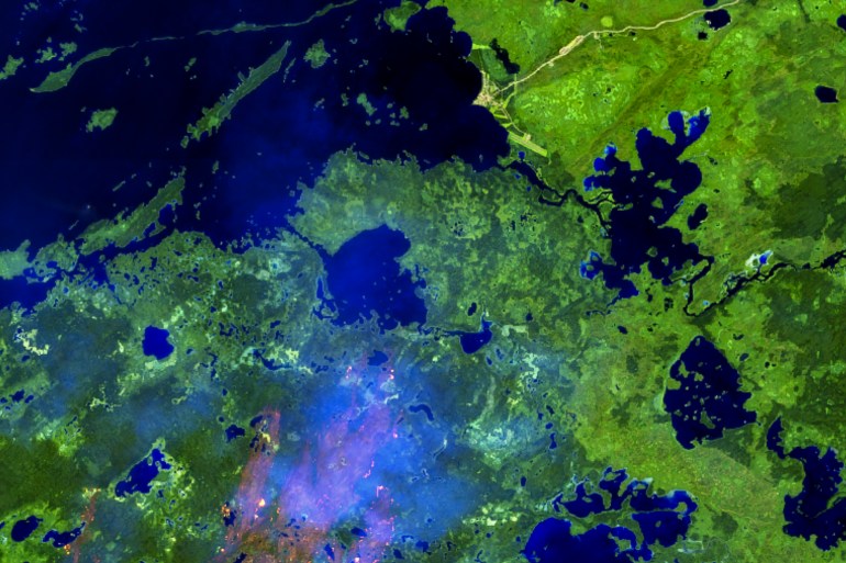 The northern edge of wildfire ZF048 is seen near the community of Whatì in a false-colour Sentinel satellite image on August 27, 2025.
