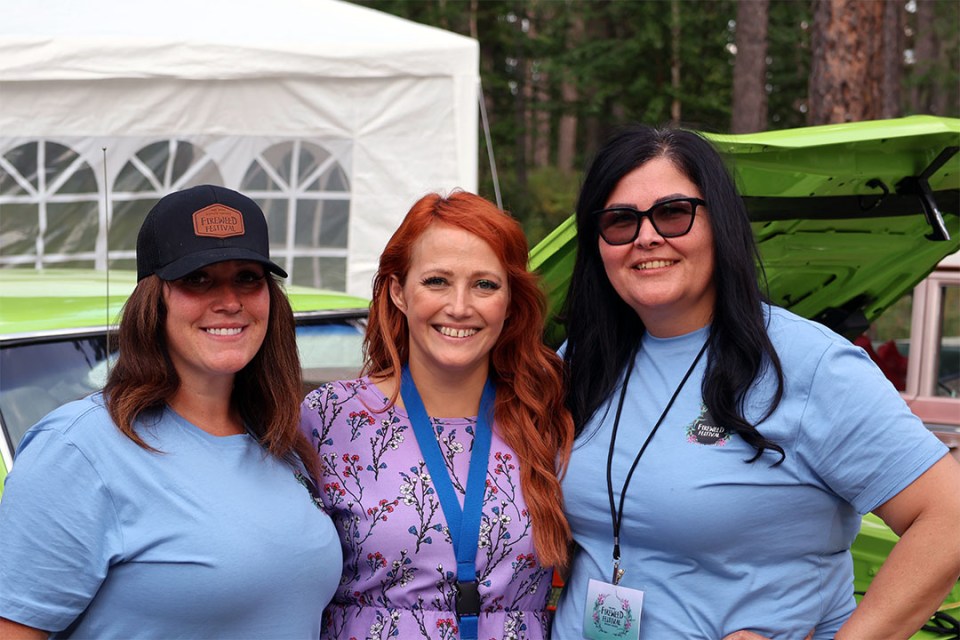 Three women pose for the camera