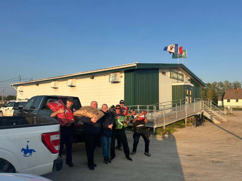 Volunteers in Fort Providence with donated dog food. Photo: Kevin Devoe