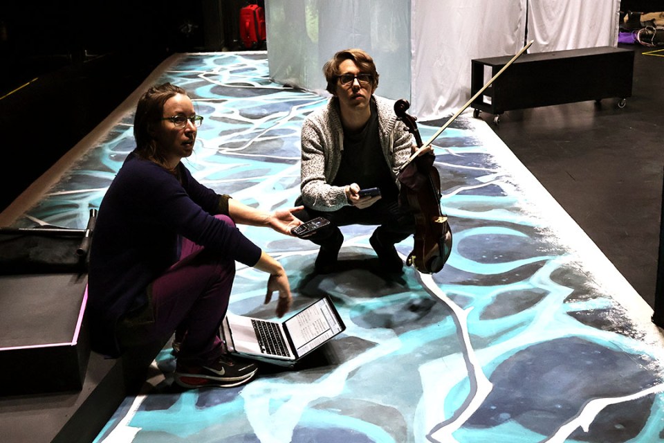 Two women sitting on stage