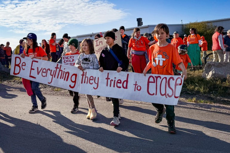 Children march with a banner on the National Day for Truth and Reconciliation on September 30, 2025. Ollie Williams/Cabin Radio