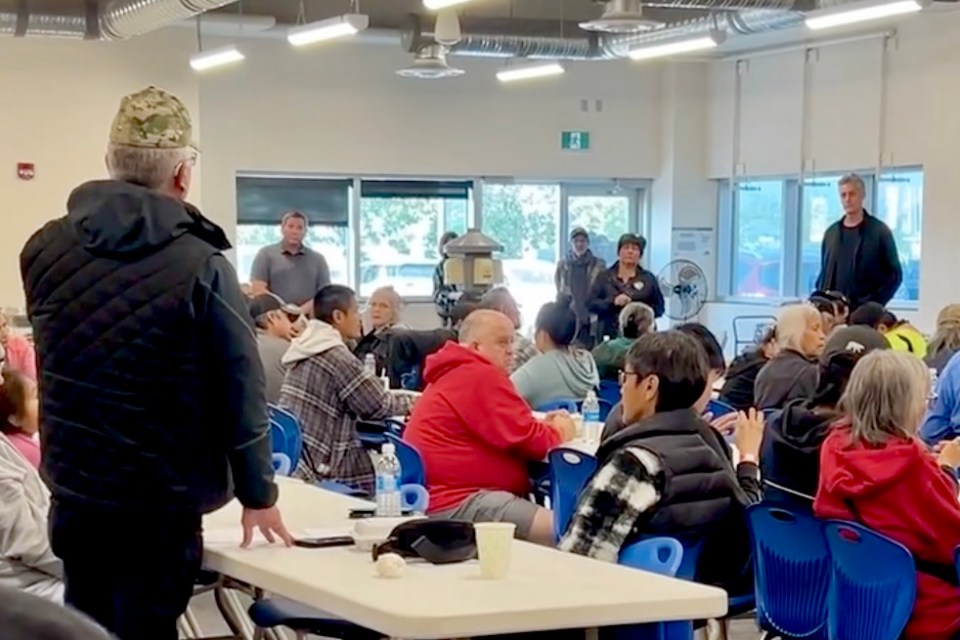 In a still from a video posted online, Michael McLeod, standing on left, is seen addressing a room that includes Premier RJ Simpson and communities minister Vince McKay.