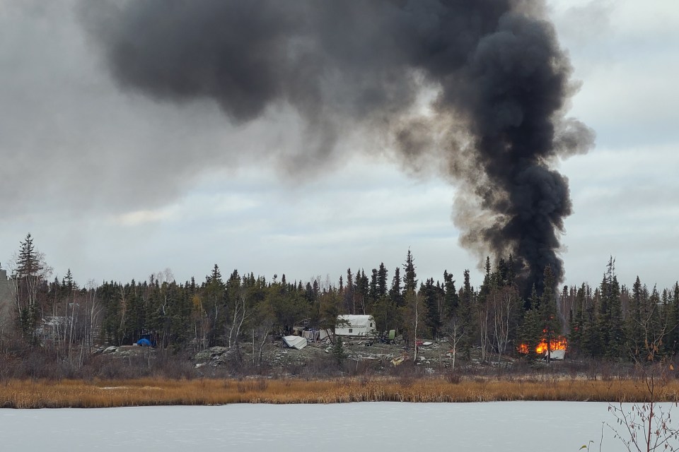 Wednesday's encampment fire as seen from across Frame Lake. Photo: Phil Pawlik