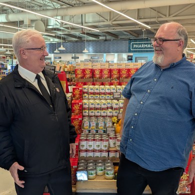 Salvation Army executive director, Tony Brushett, left, and Lakeshore Co-op general manager, Justin Nelson, right, in October 2025. Sarah Pruys/Cabin Radio
