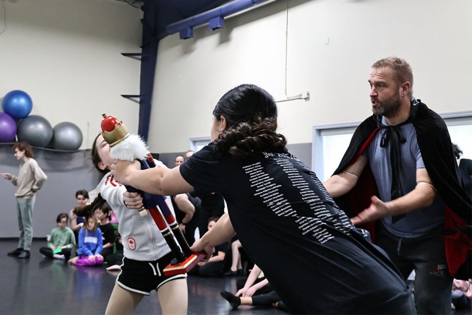 Two children fight over a nutcracker toy at a ballet rehearsal
