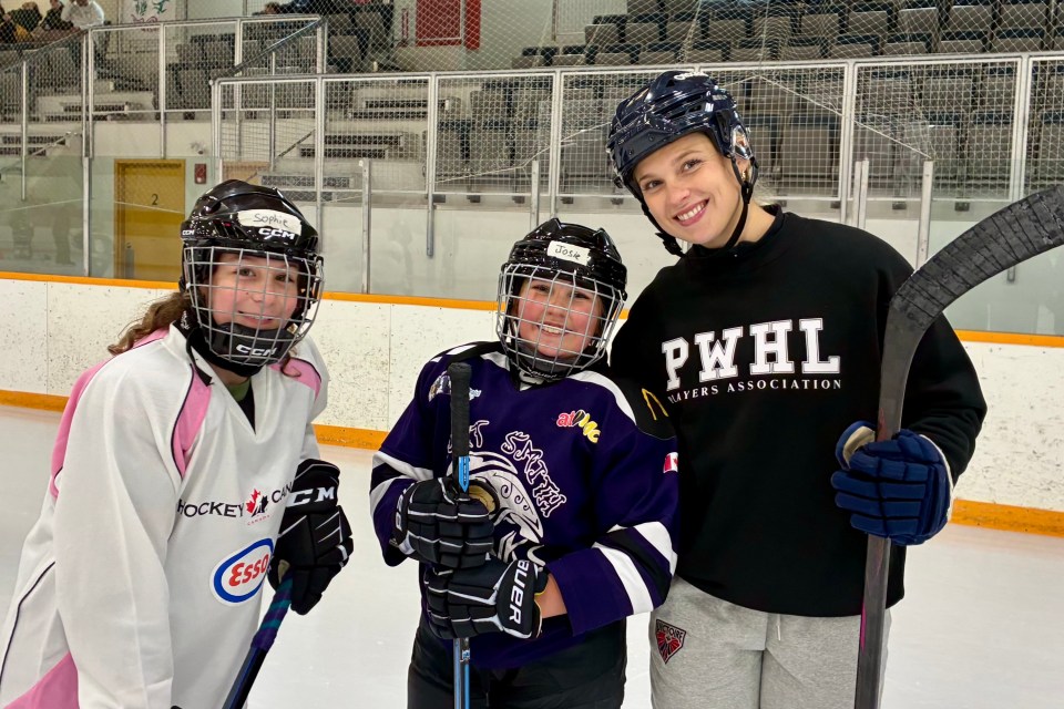 Dara Greig, right, with Fort Smith minor hockey camp attendees. Photo: Submitted