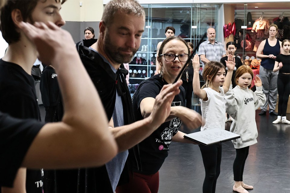 Adults and children during a rehearsal