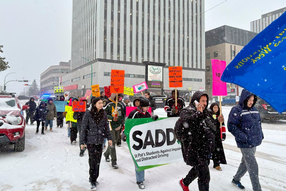 Yellowknife residents marching to recognize National Addictions Awareness Week in 2025. Jasmine Nasogaluak/Cabin Radio