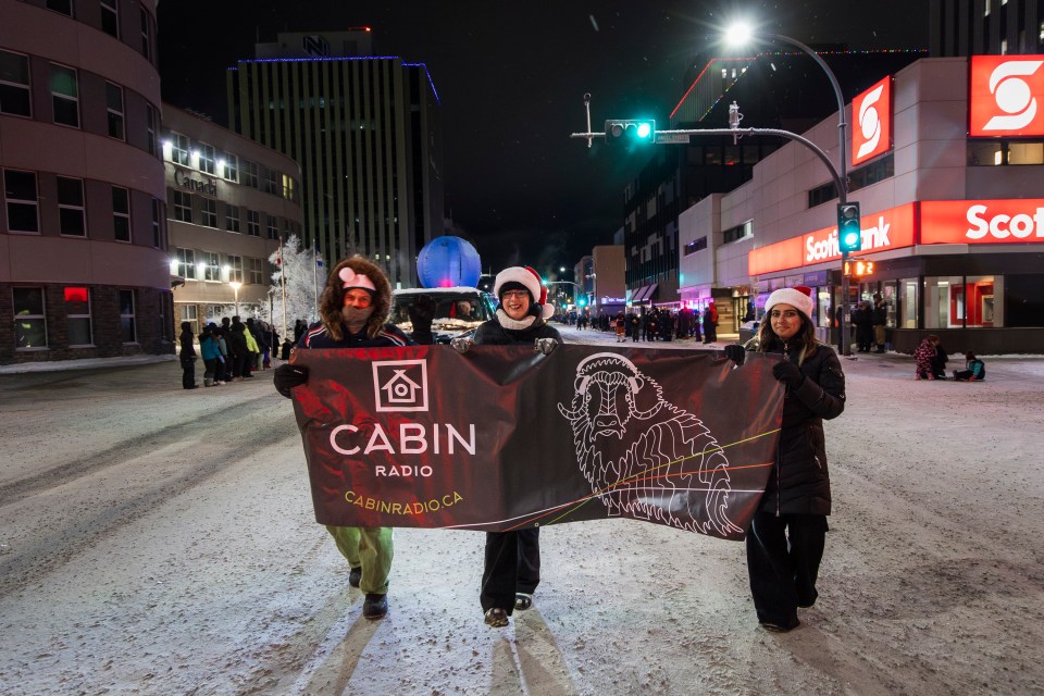 From left: Cabin Radio's Cody Punter, Miriam Bosiljevac and Aastha Sethi in the parade. Ollie Williams/Cabin Radio