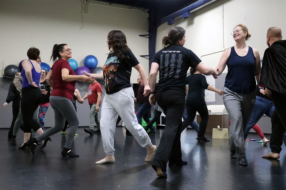 Adults rehearse a dance