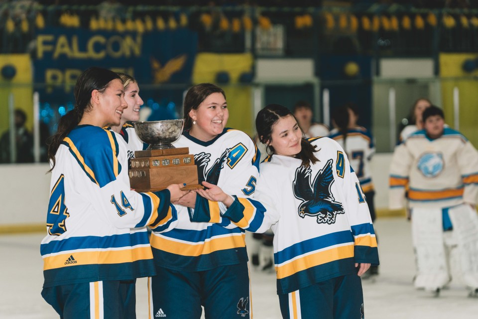 The Sir John's captain and assistant captains pose with the Wade Hamer trophy. Sarah Pruys/Cabin Radio