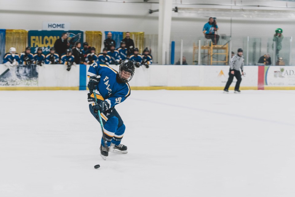 Sir John player Ben Mager grabs the puck. Sarah Pruys/Cabin Radio