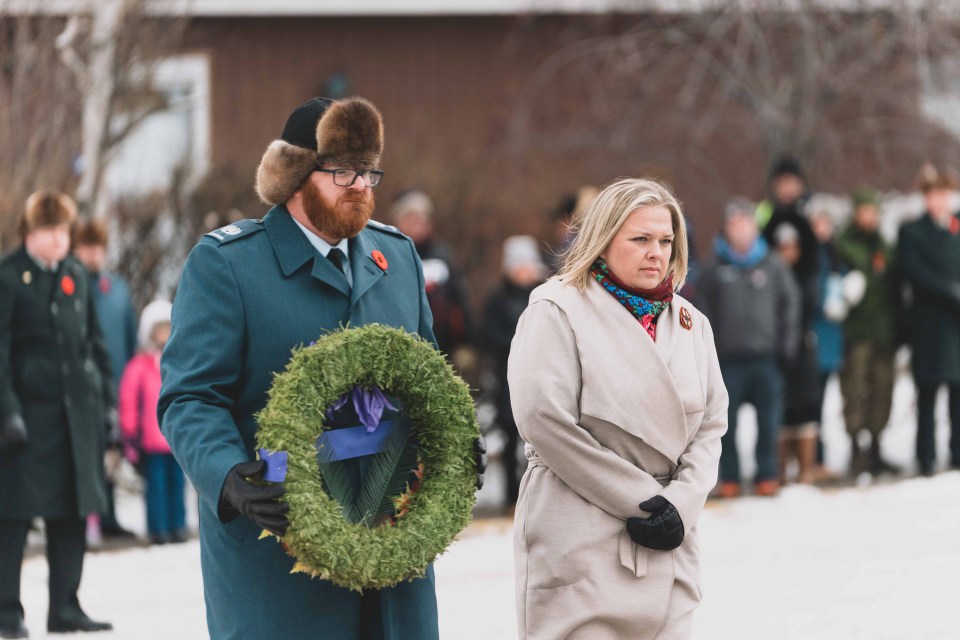 MLA Cailtin Cleveland, who also serves as Minister of Education, Culture & Employment and Minister of Industry, Tourism & Investment, lays a wreath. Sarah Pruys/Cabin Radio